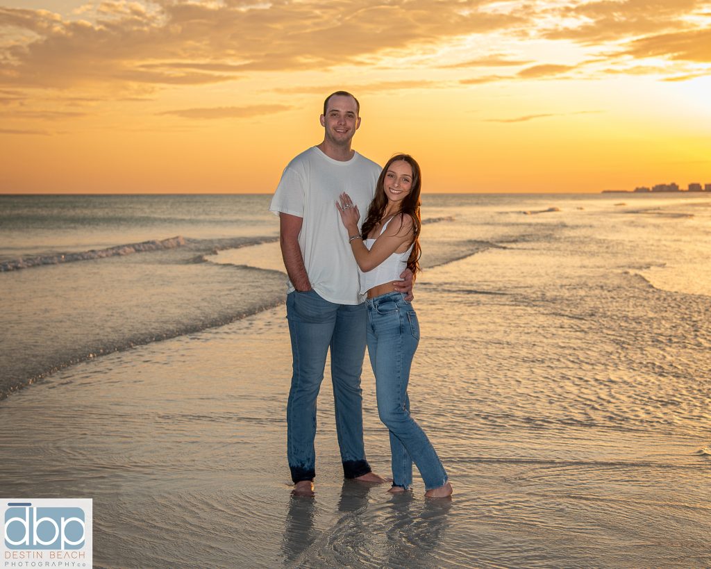 Couple beach photographer captures young couple during sunset.